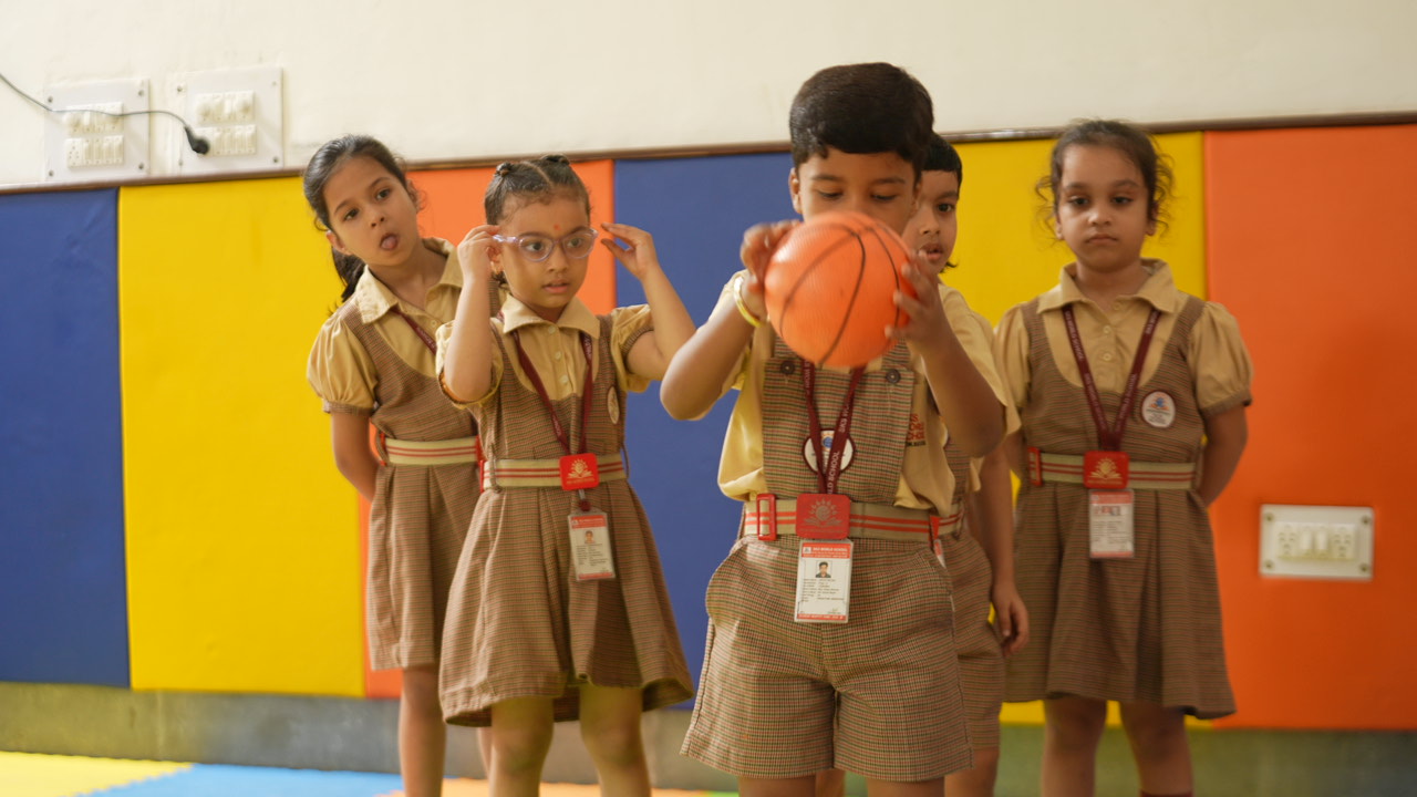 Student with a basketball at SKS World School, Sector 137