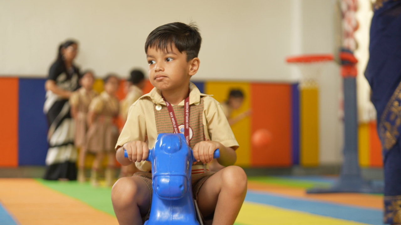 Nursery child on a rocking horse in the play area