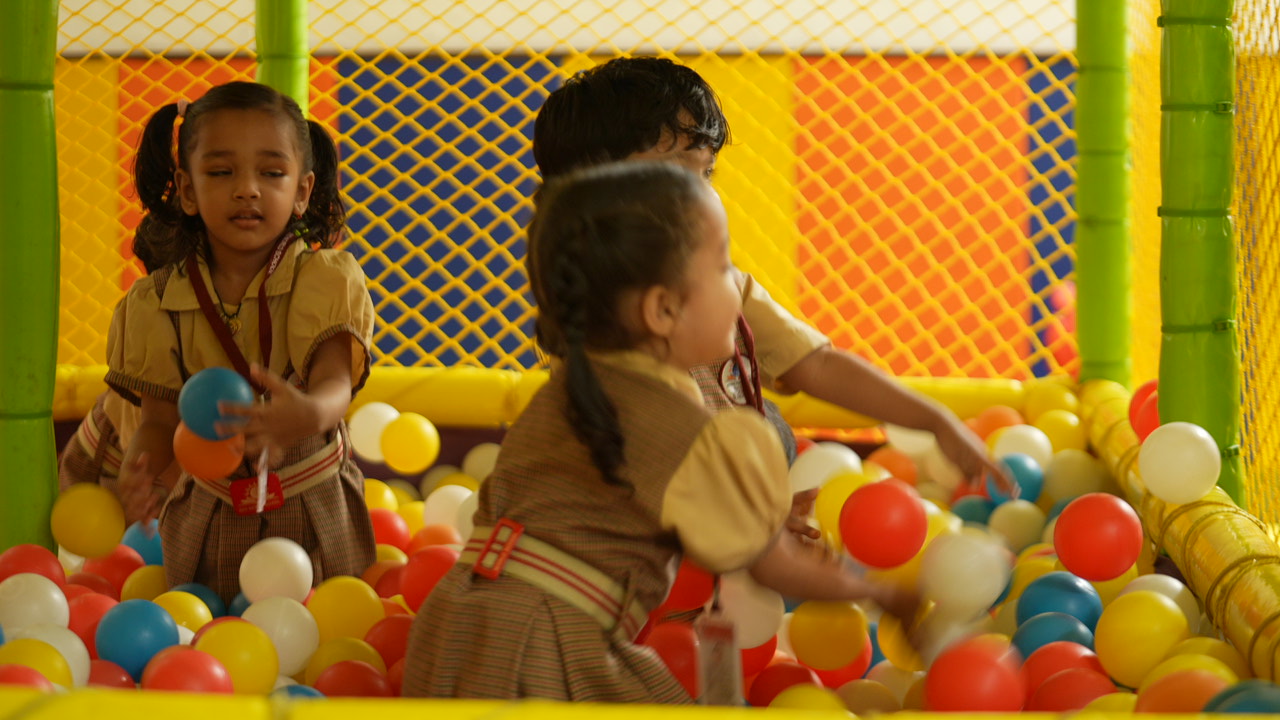 Young SKS World School children playing together in the colourful ball pit